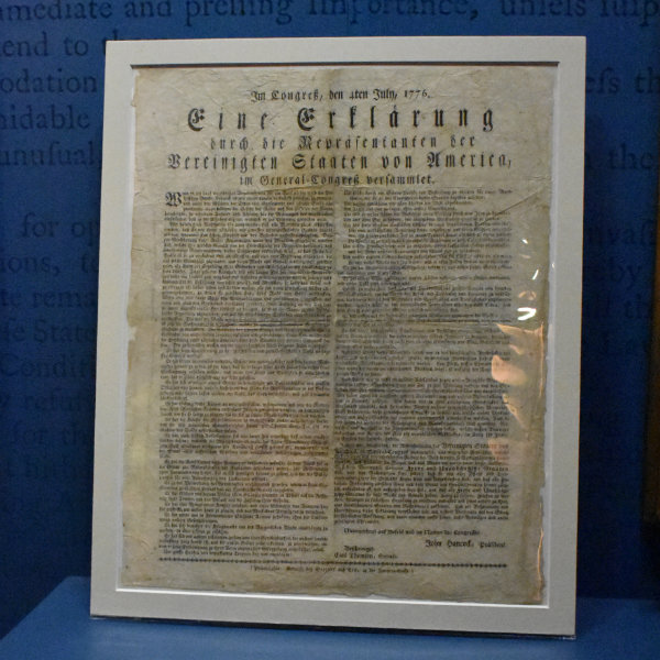 The German-language Declaration of Independence framed and lit for display.